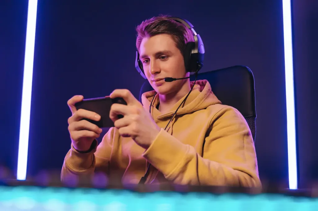 Young man playing a game on a mobile phone.